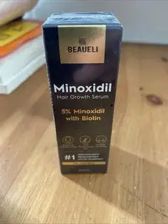 Beaureli Minoxidil Hair Growth Serum box with black and gold design, highlighting 5% Minoxidil with Biotin for hair revitalization, SKU: CJJT200336001AZ